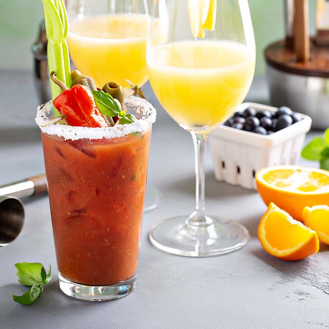 Bloody Mary and mimosa cocktails at E.J.'s Diner Wausau, garnished with orange and blueberries.