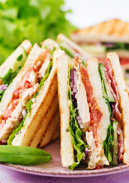 Club sandwiches with chicken and veggies, stacked high at E.J.'s Diner Wausau.