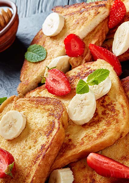 French toast slices topped with banana, strawberries, and mint at E.J.'s Diner Wausau.