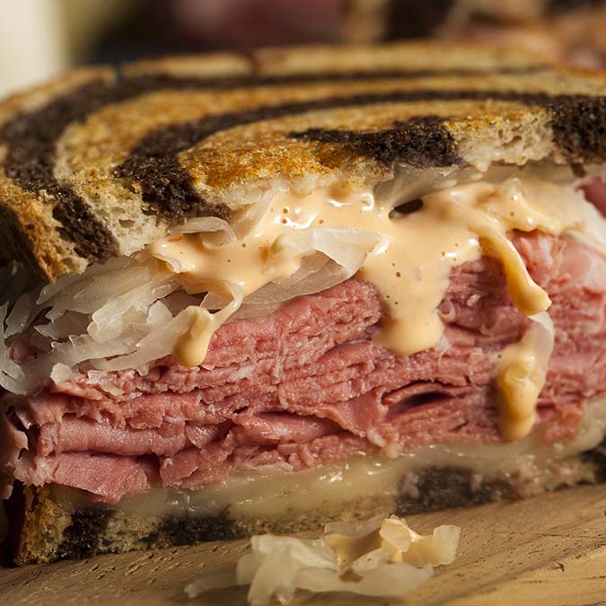 Close-up of a Reuben sandwich at E.J.'s Diner Wausau with rye, corned beef, and sauerkraut.