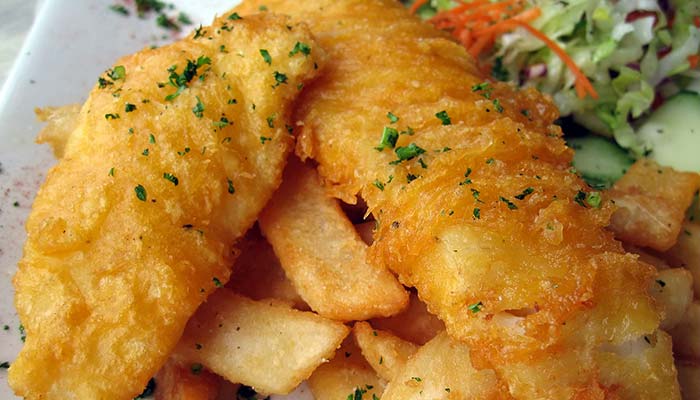 Golden fried fish fillets on thick-cut fries—try this Restaurant Specials Wausau favorite!.