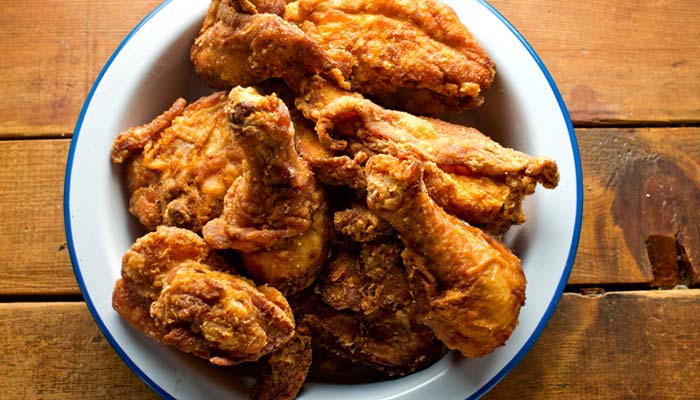 A bowl of crispy fried chicken pieces, perfect for lunch in Wausau WI, on a wooden table.