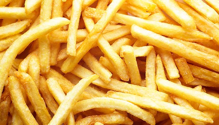 A close-up of golden, crispy French fries stacked together for lunch in Wausau, WI.
