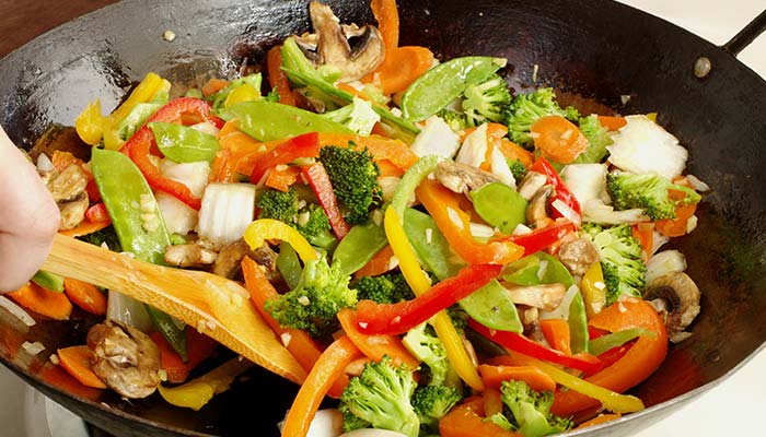 Colorful mixed vegetables being stir-fried in a wok—perfect for lunch in Wausau, WI.